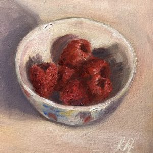 Raspberries in a blue bowl still life
