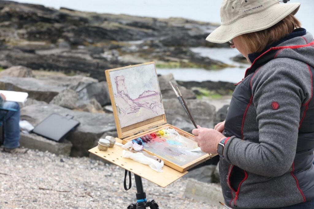 Irish Artist Karen Wilson painting at Donabate beach at the Dublin Plein Air Festival 2024