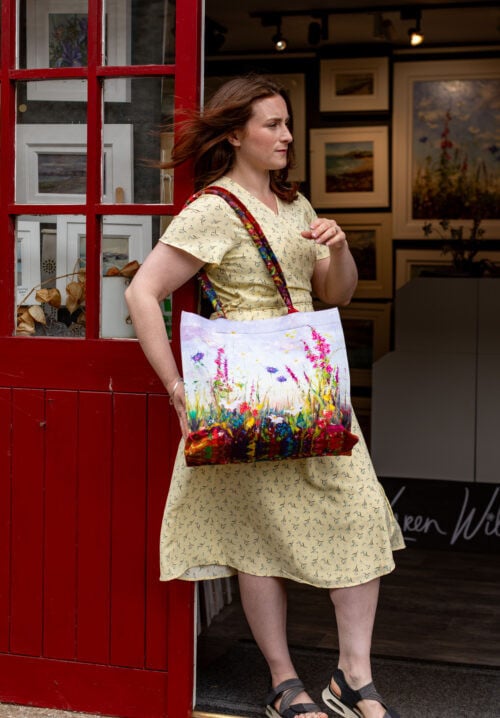 WOMAN WEARING FLORAL FLURRY ART TOTE BAG DESIGNED IN IRELAND